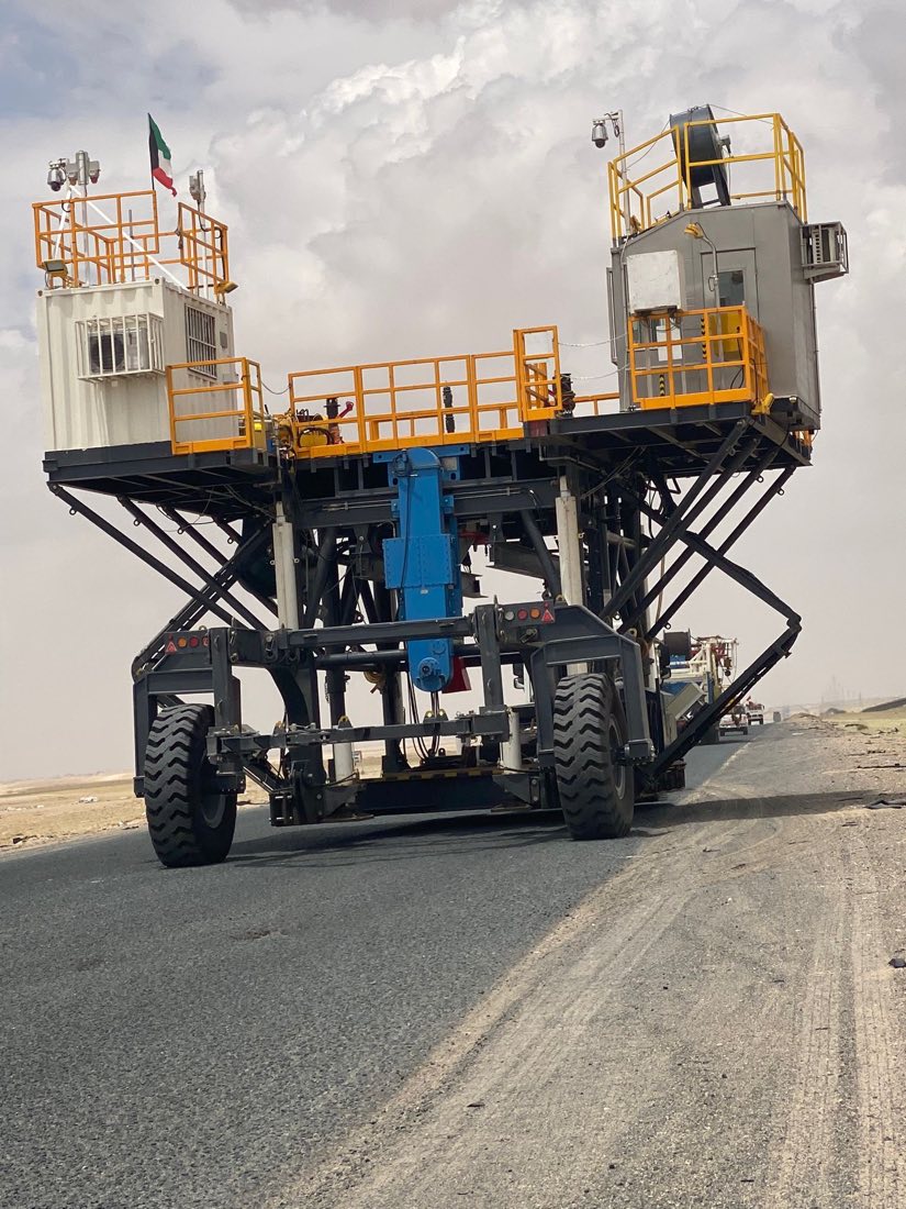 Self-propelled rig mover carrying rig module across the desert